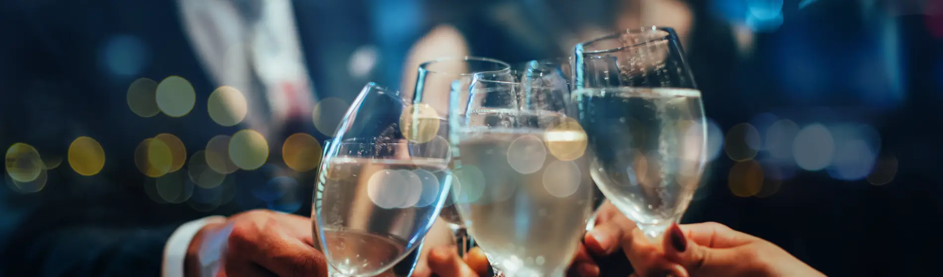 Group of professionals holding their champagne glasses in a cheers.