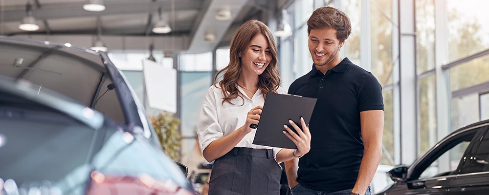 Couple at a car dealership