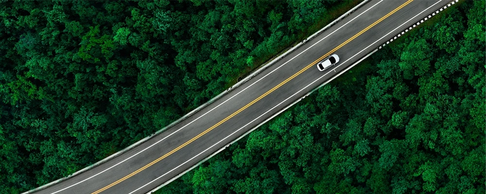 Aerial view of car driving down a highway