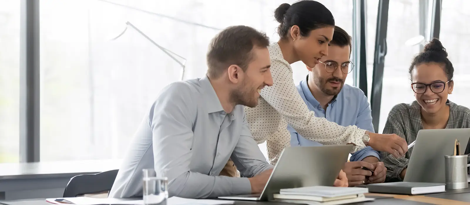 HR Team Gathered Around Their Laptops