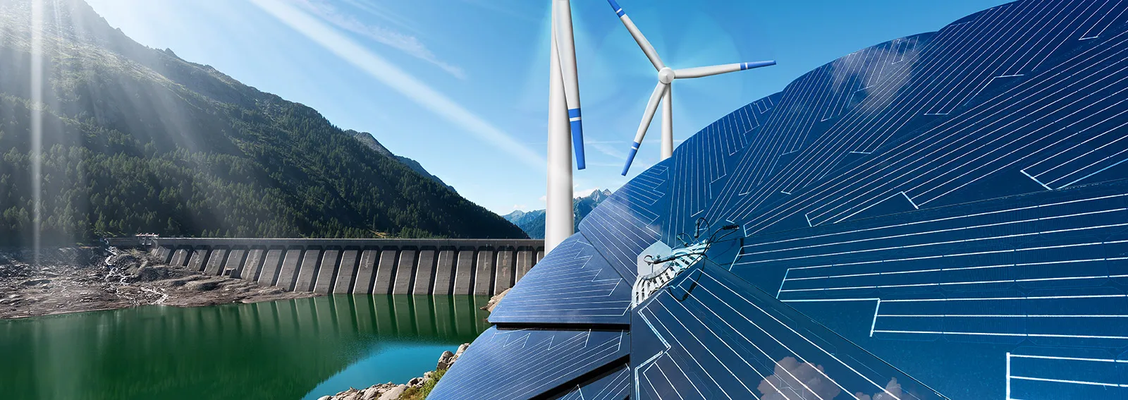 Windmills with mountains in the background on a sunny day