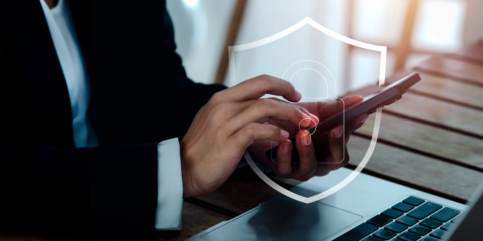 Business person using phone with cyber insurance protection