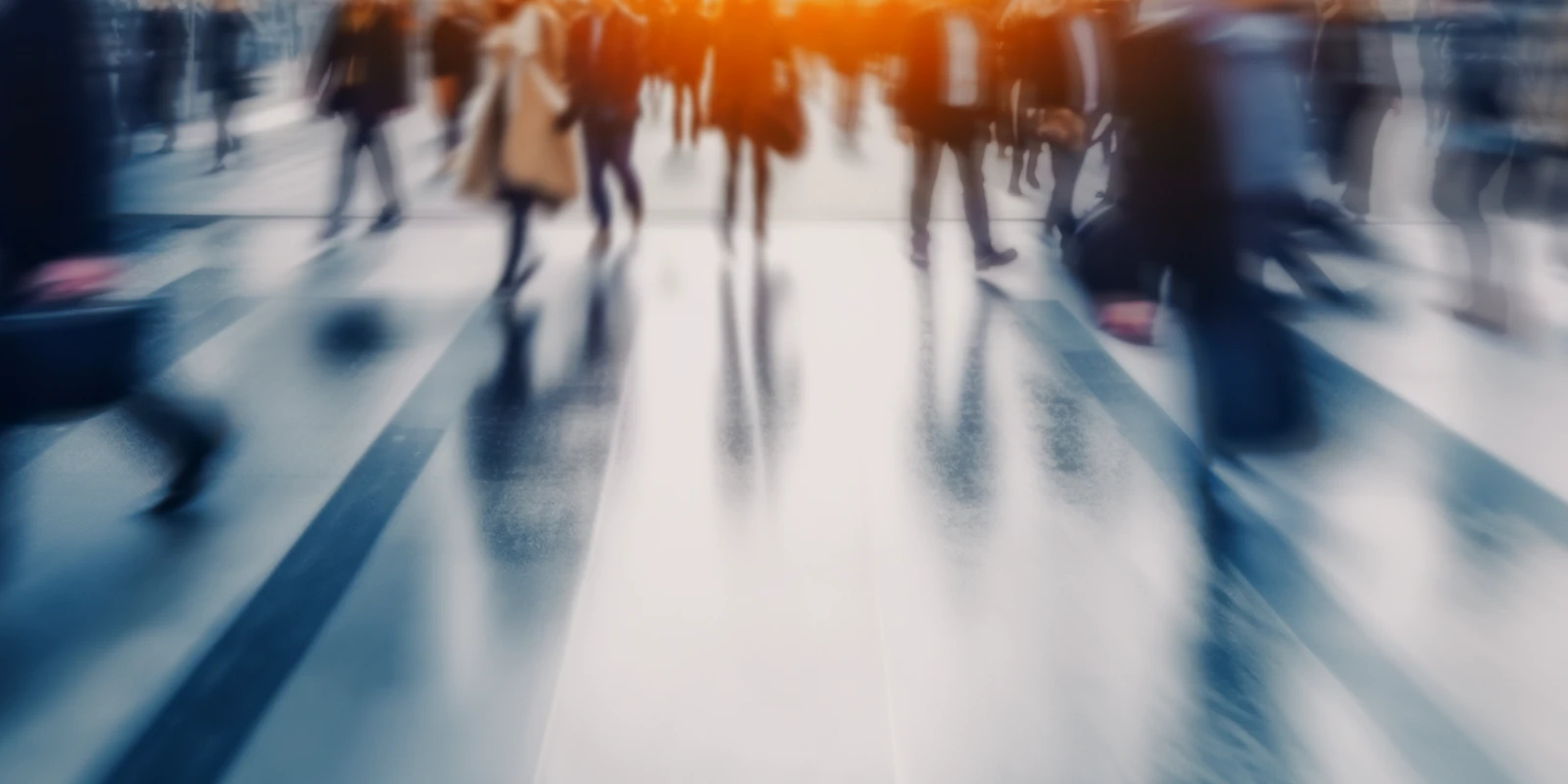 Blurred photo of people walking on a busy street