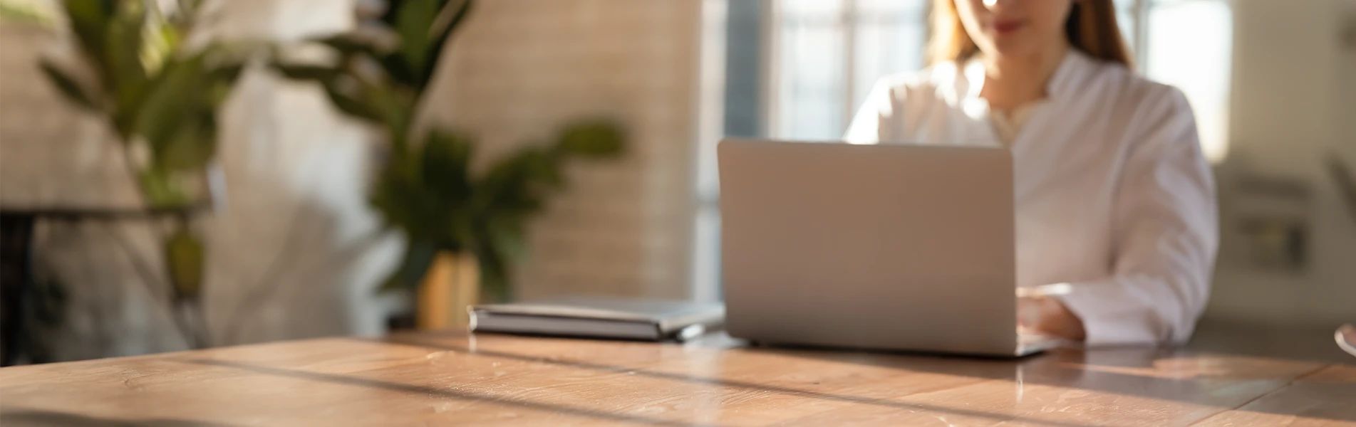 Female professional watching a webinar on a laptop.