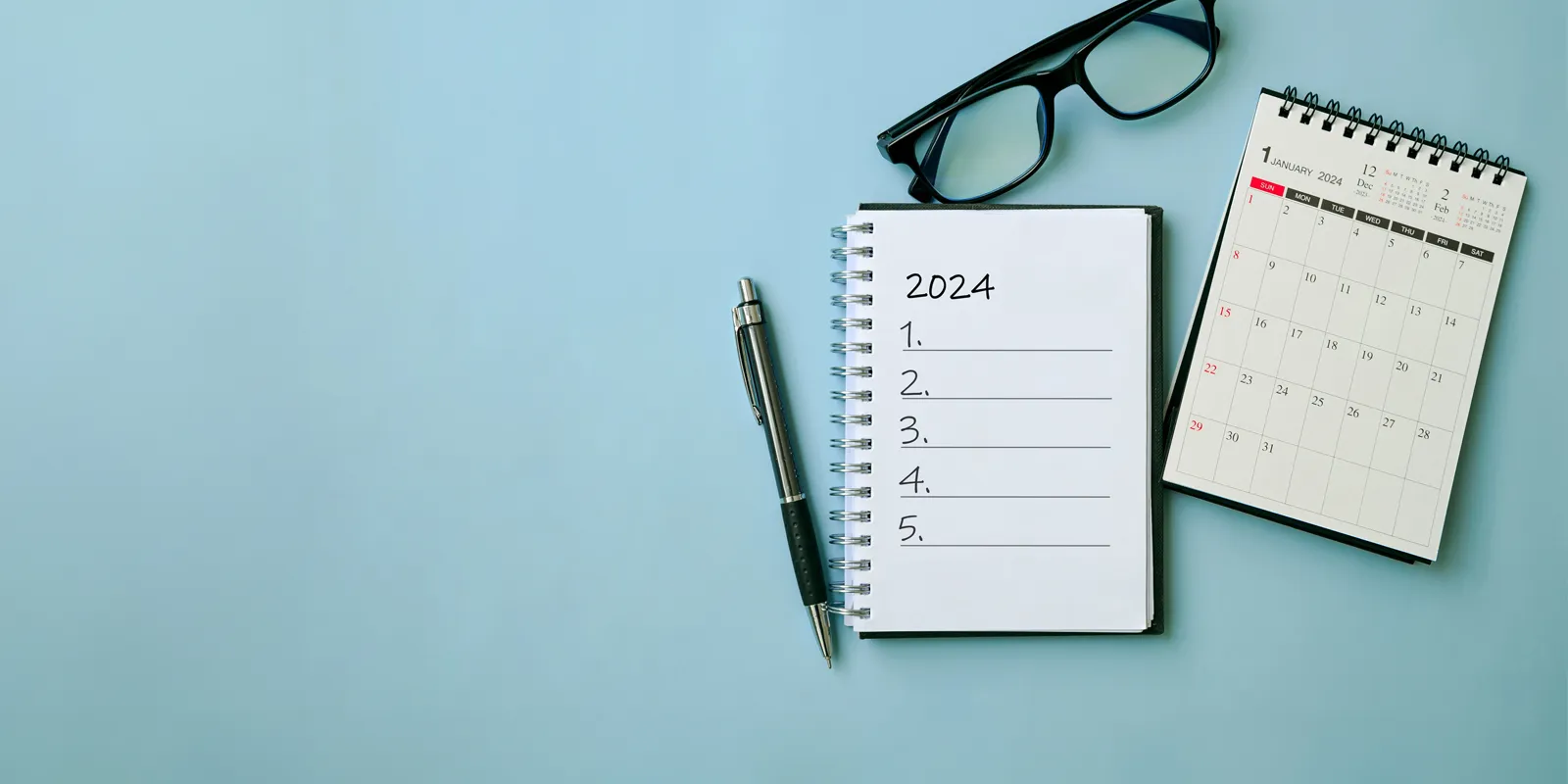 Blue desk with a notepad and a calendar