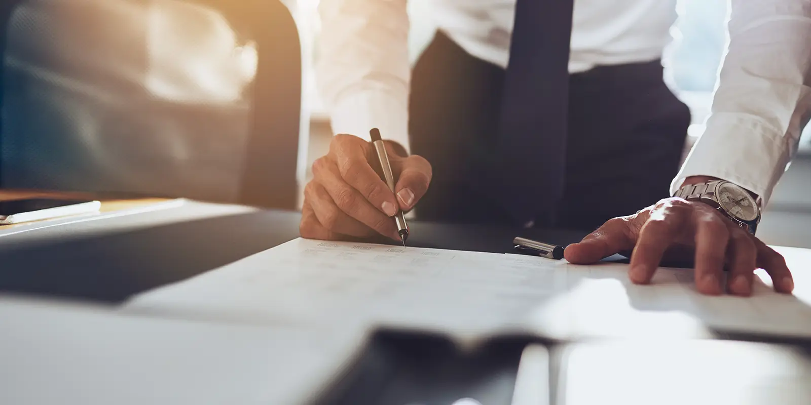 Close up business man signing contract making a deal classic business