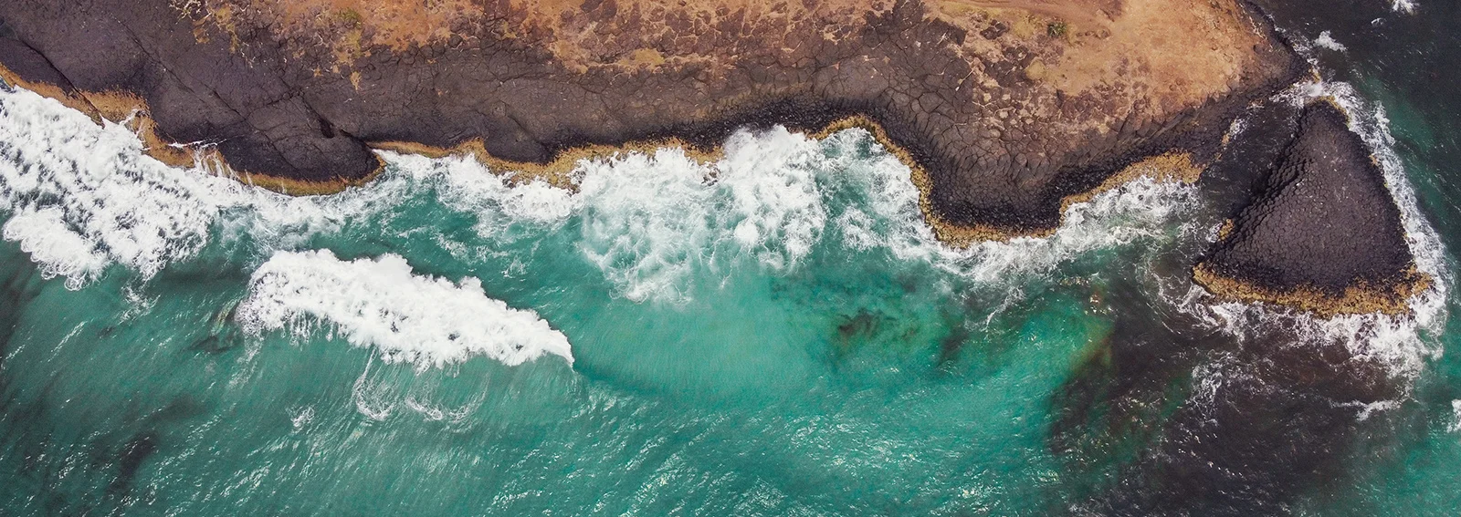 Ocean water splashing against rocks