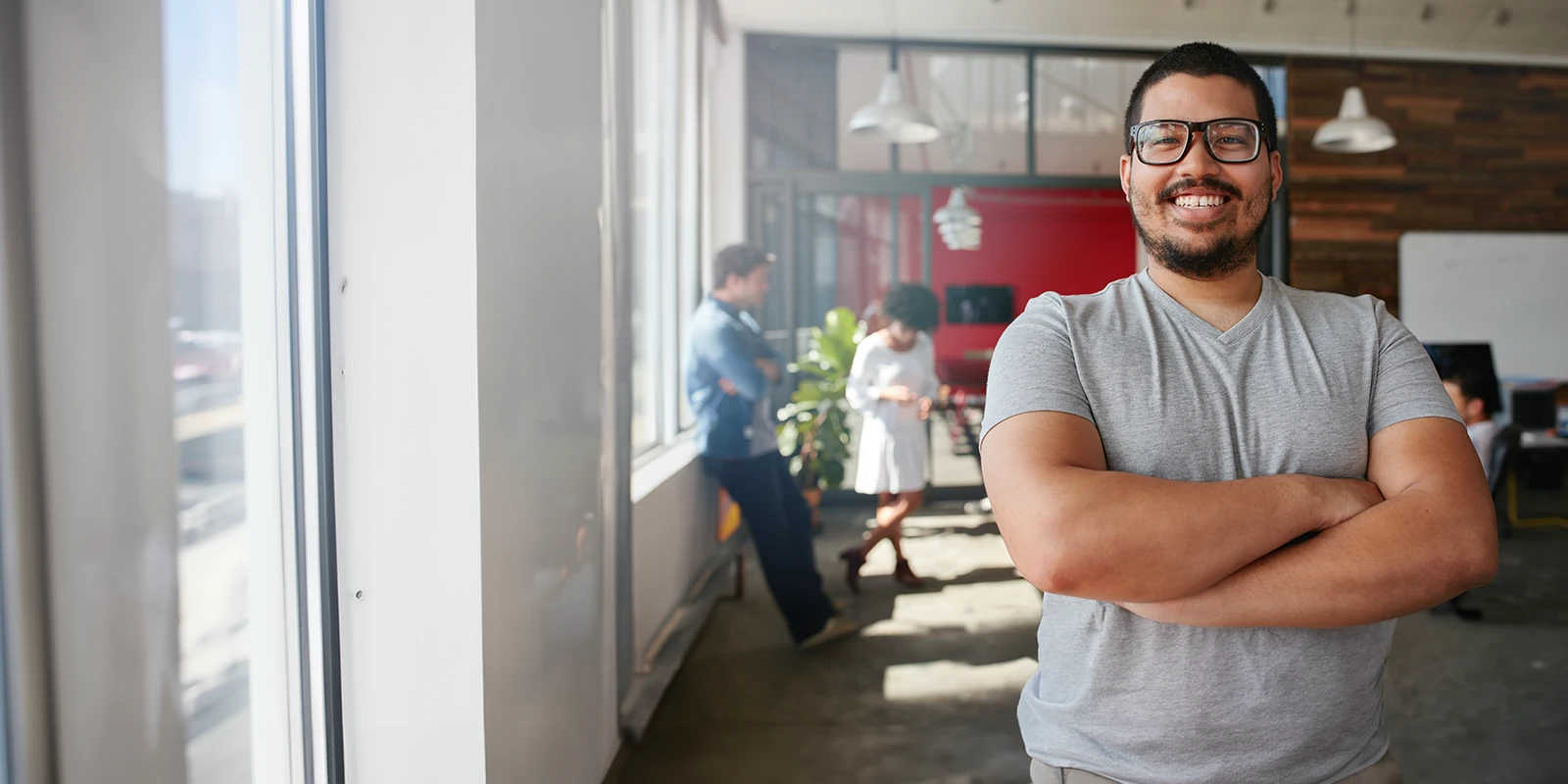 proud employee with arms crossed in modern office