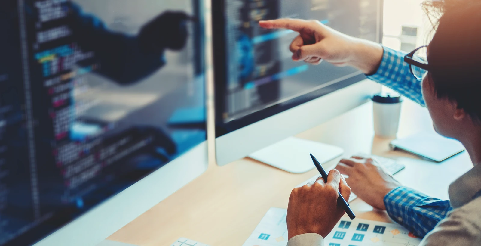 Person pointing at computer screen