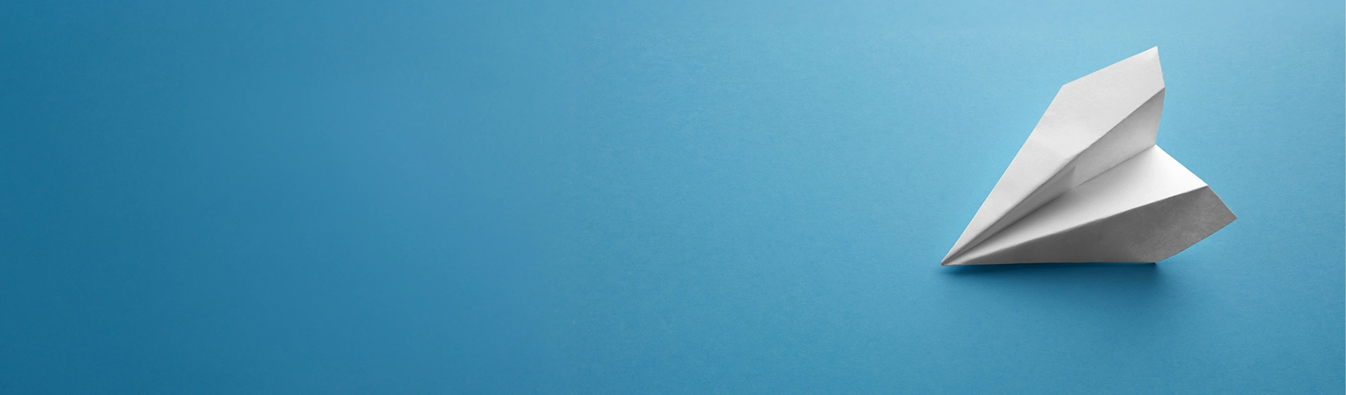 paper airplane on a blue background