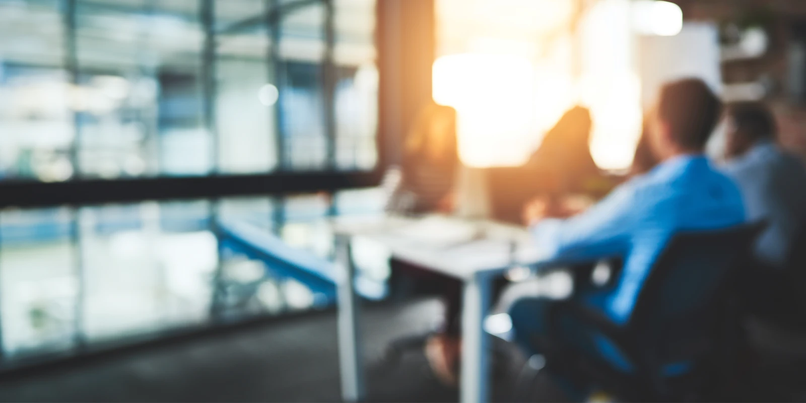 Blurry background of an office and workers.