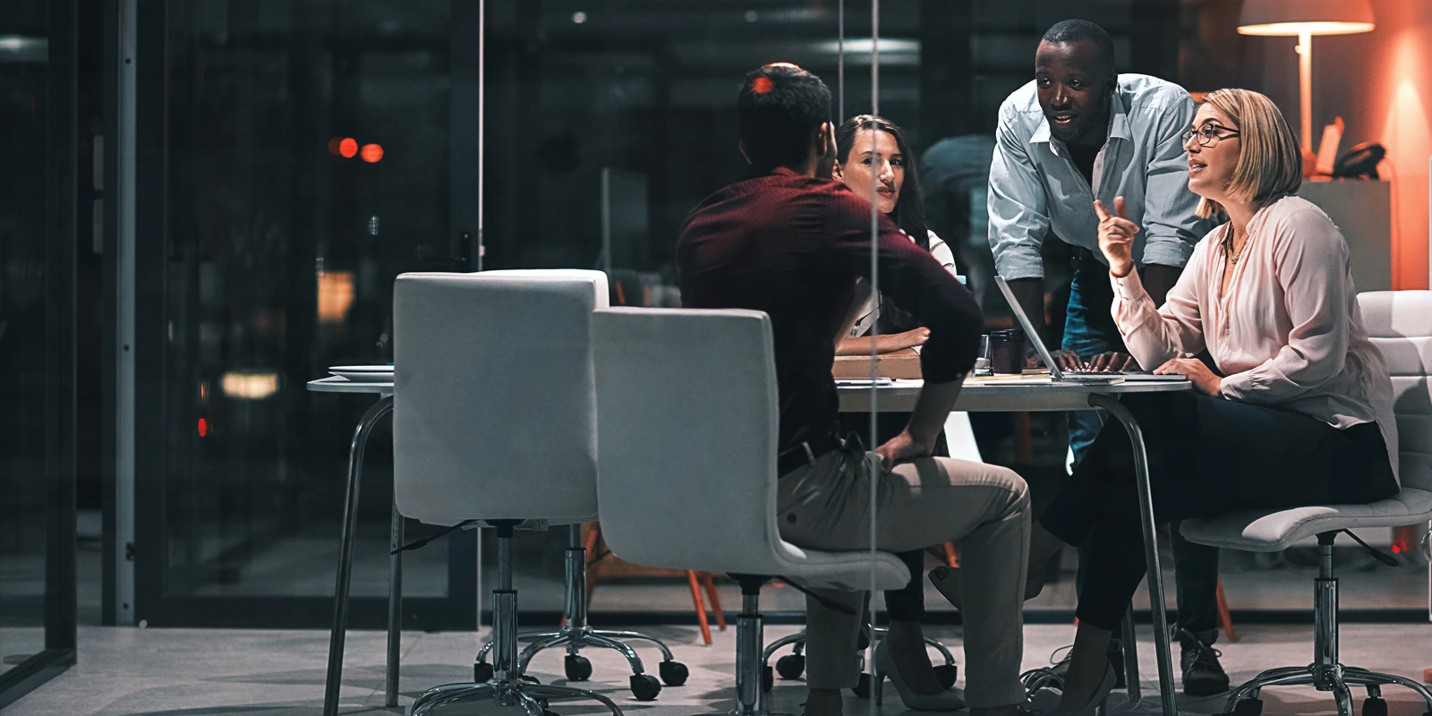 Group of professionals at a meeting in a boardroom.