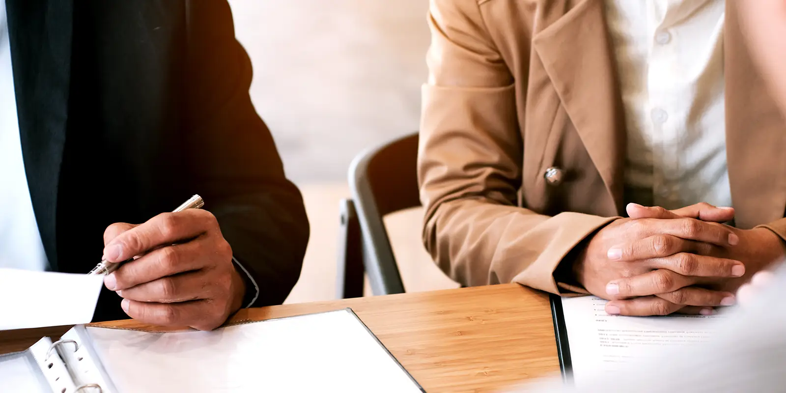 People at a desk discussing how the mortgage industry can comply with FINTRAC’s anti-money laundering obligations