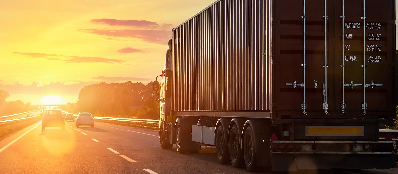 front view big long heavy semi-treailer truck with shipping container driving highway